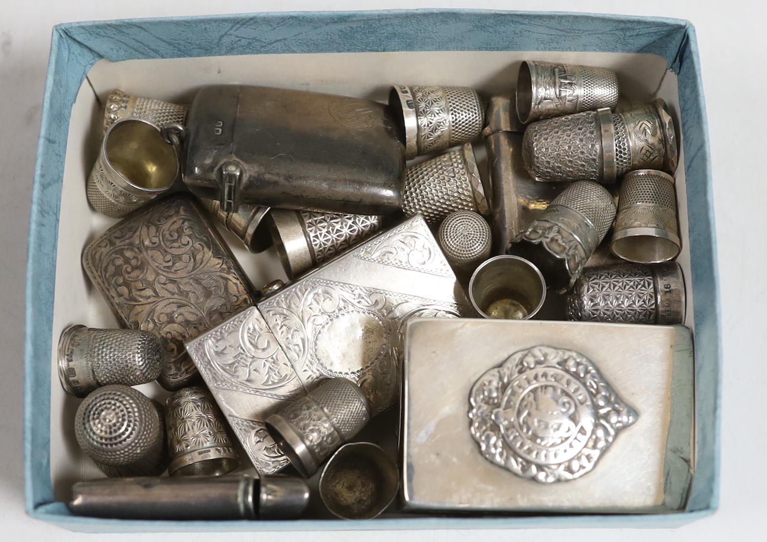 Five assorted early 20th century silver vesta cases, a similar French white metal vesta case, a silver matchbox sleeve, a sterling lighter, together with fifteen silver thimbles including Charles Horner, two sterling thi